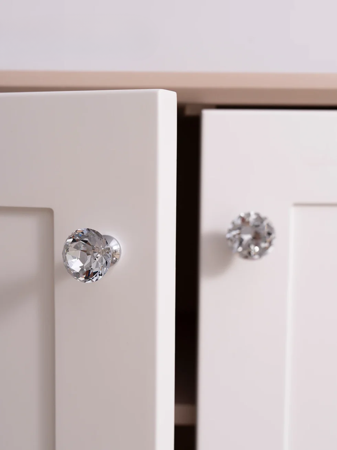 Close-up of a pair of silver stud earrings on a white background