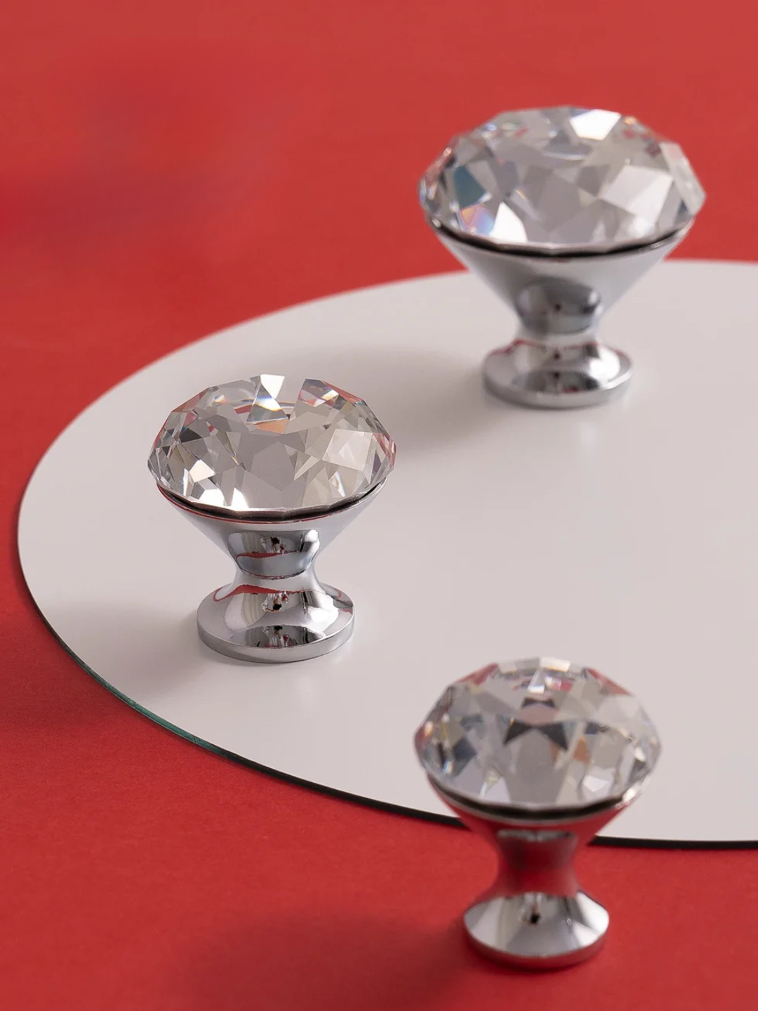 Crystal cabinet knobs on a red and white background