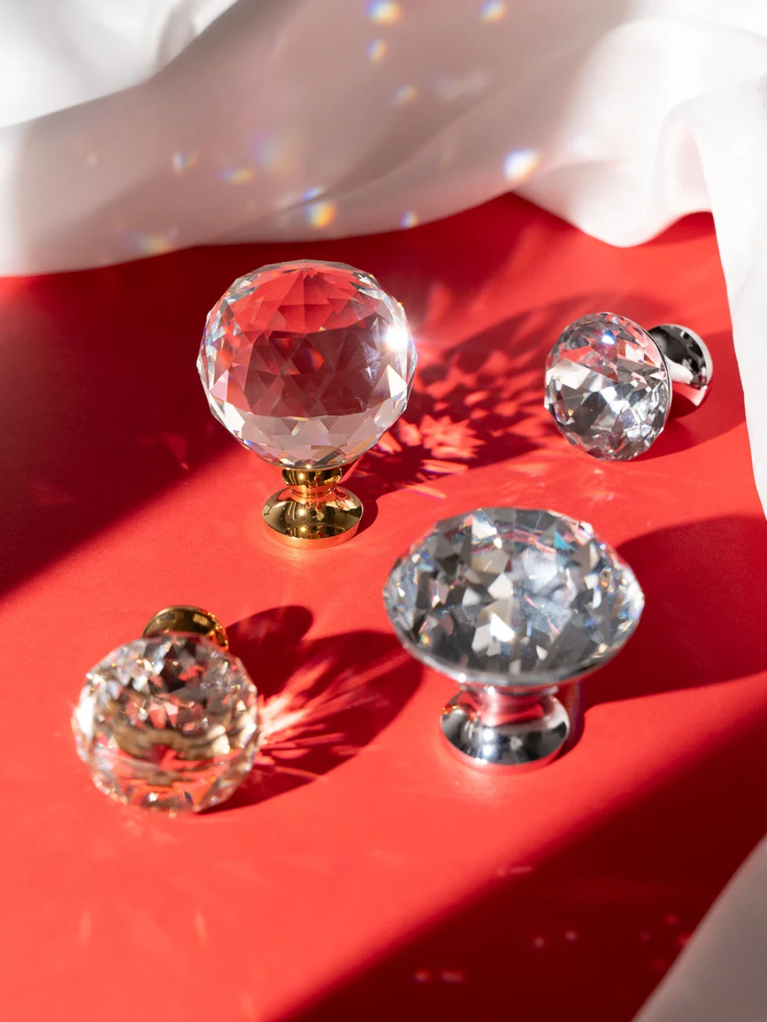 Crystal knobs on a red surface with a white background