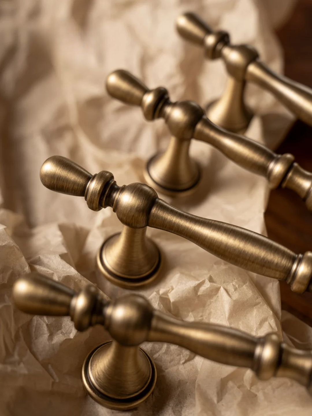 Close-up of brass door handles on a textured surface