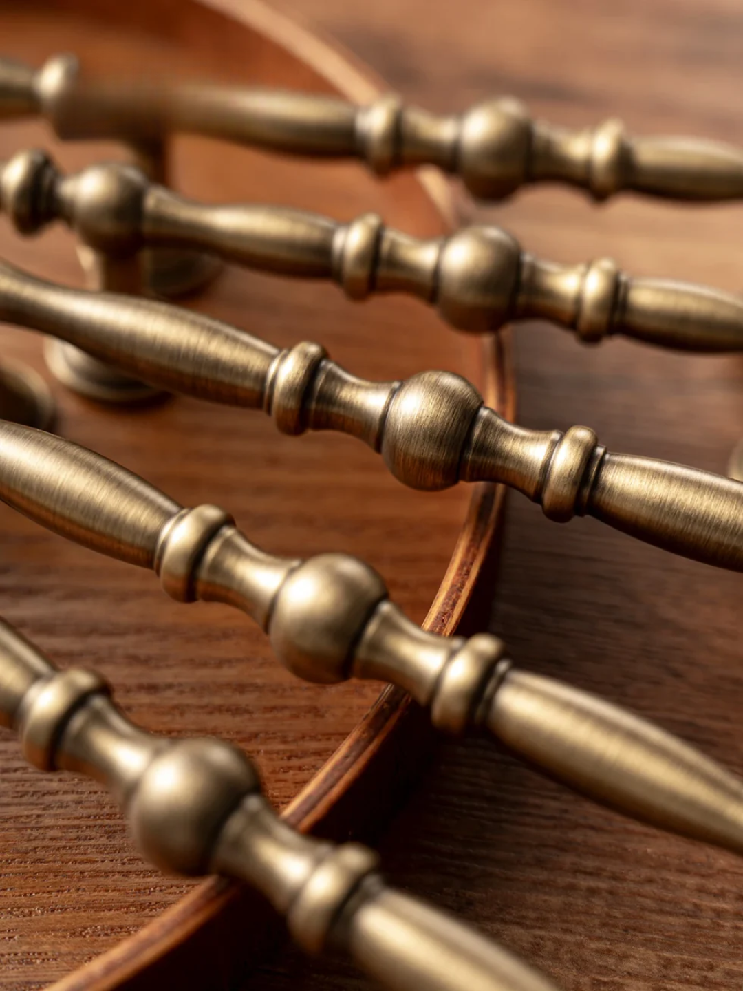 Close-up of decorative brass handles on a wooden surface