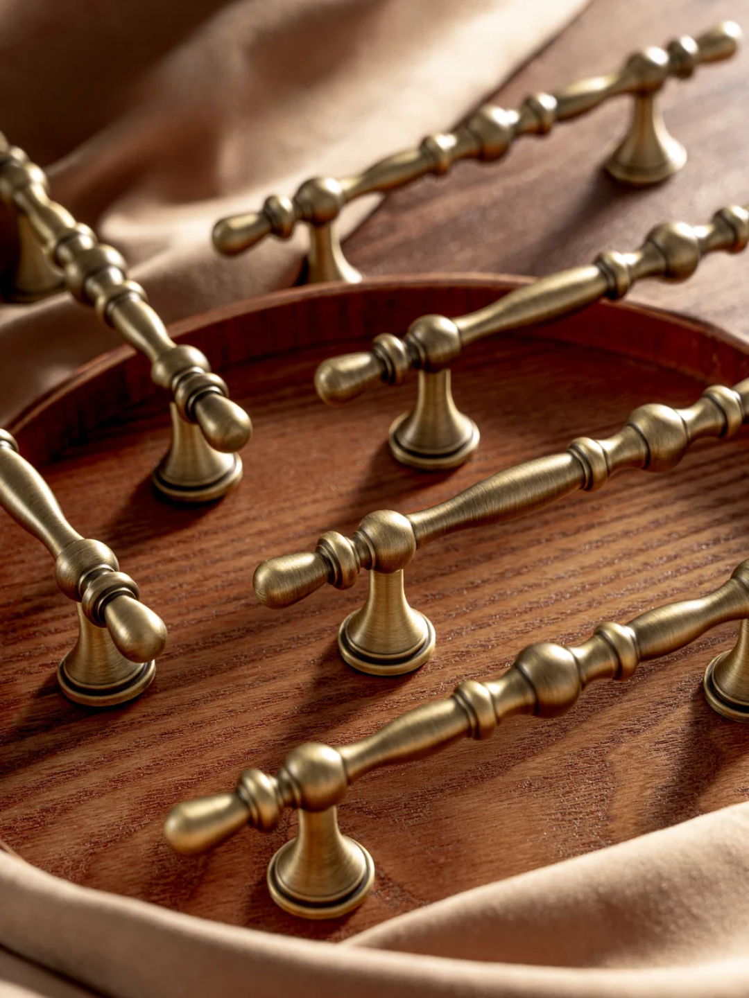 Pair of bronze cabinet handles on a neutral background