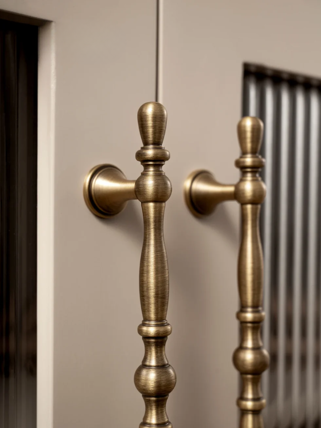 Pair of bronze cabinet handles on a neutral background
