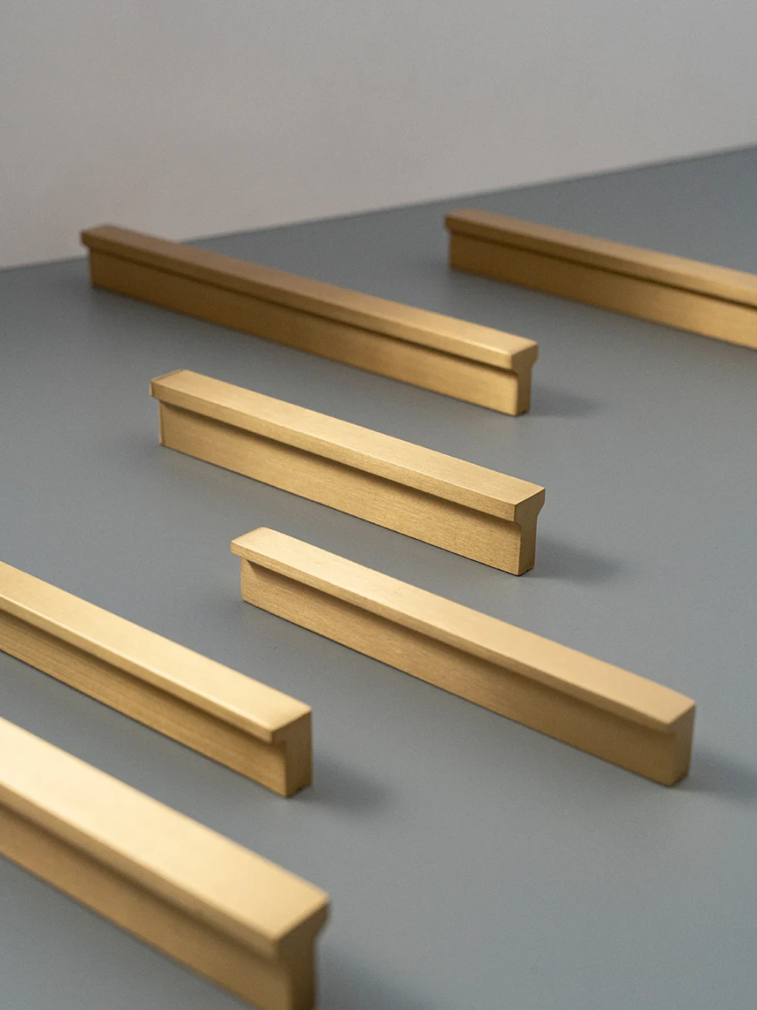 Set of gold metal bars on a gray surface
