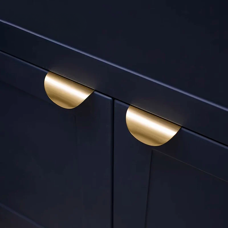 Navy blue cabinet with gold handles on a dark background