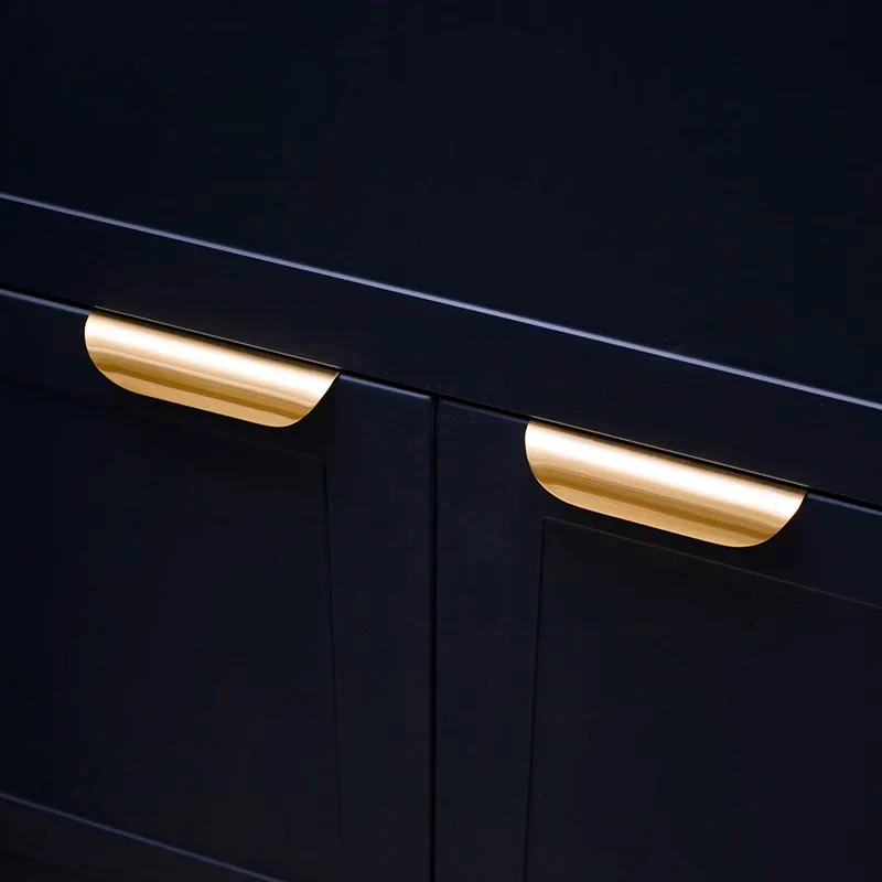 Black cabinet with gold handles on a black background