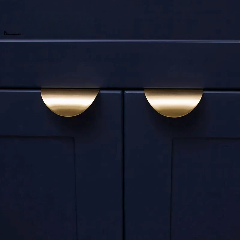 Navy blue cabinet with gold handles on a dark background