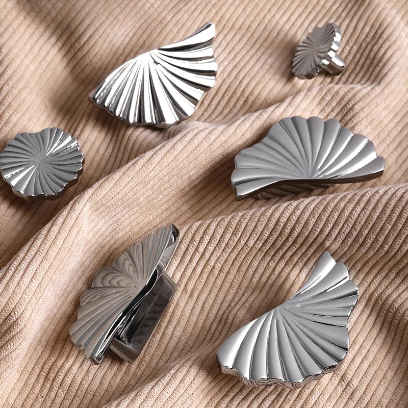 Silver decorative elements on a beige fabric background