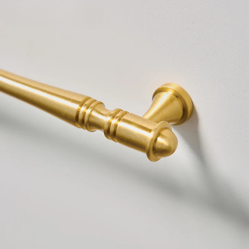 Gold towel bar on a light gray background