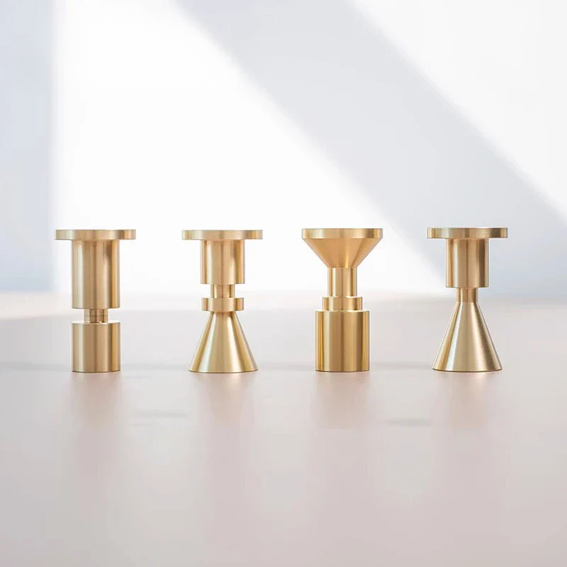 Four gold candle holders on a white background