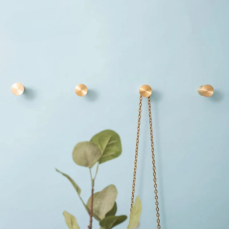 Gold necklace with a chain on a light blue background