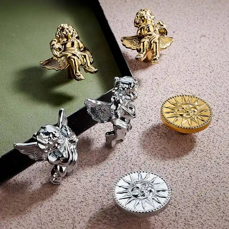 Gold and silver angel figurines on a textured surface