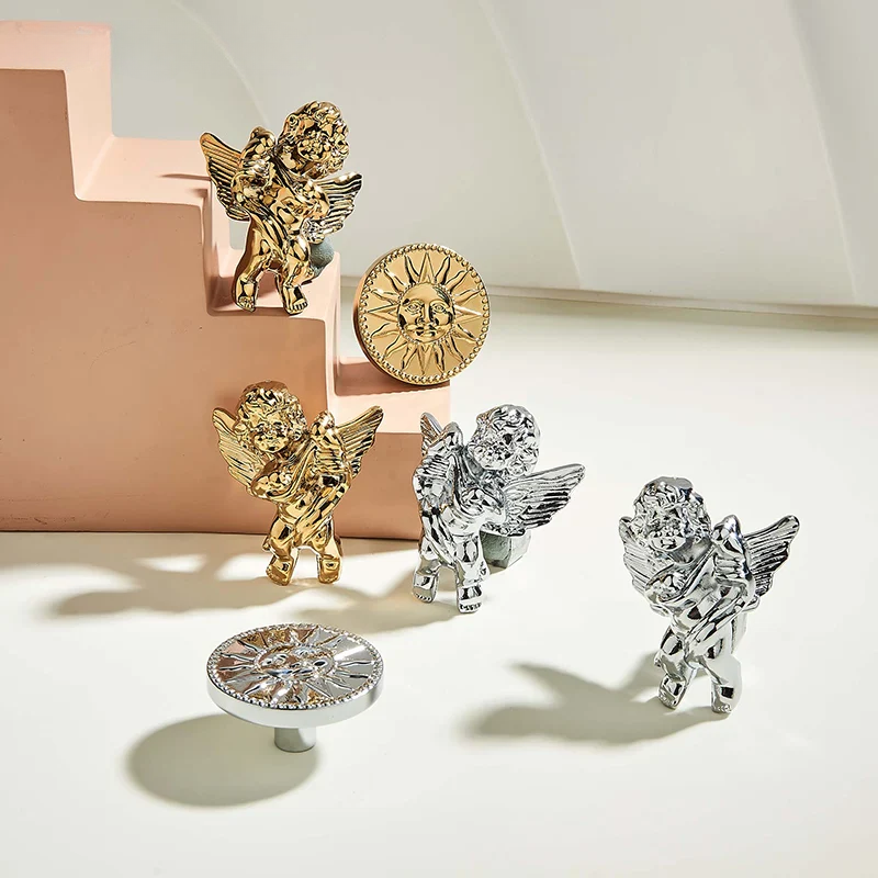 Gold and silver angel figurines on a textured surface