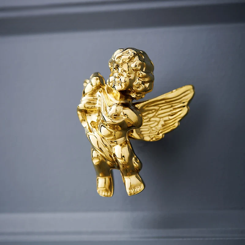 Gold cherub angel figurine on a dark gray background