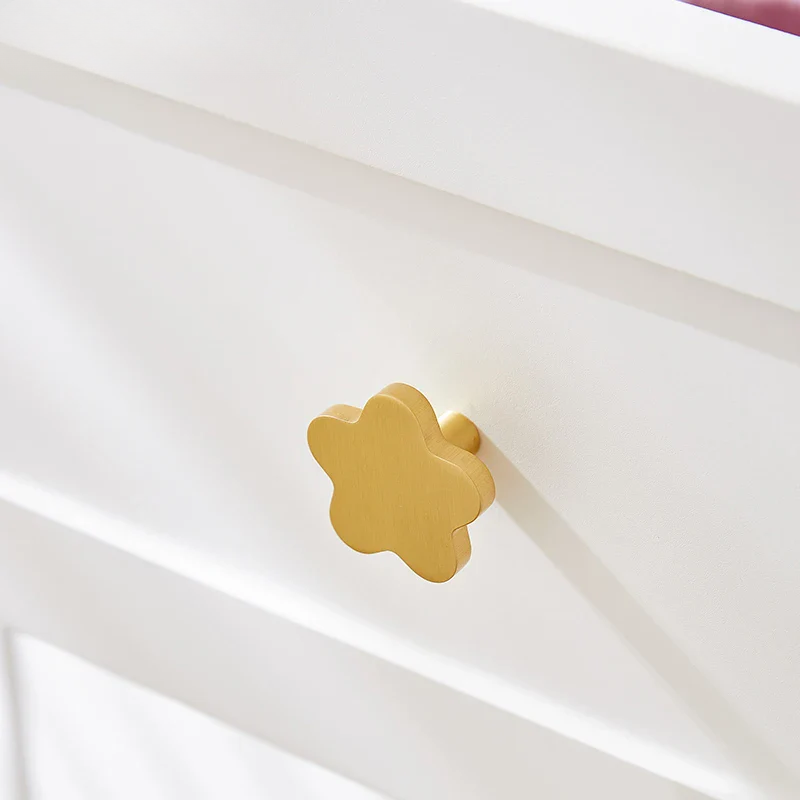 Gold flower-shaped object on a white background