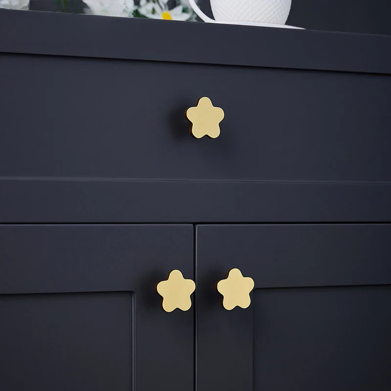 Dark blue cabinet with gold star-shaped handles