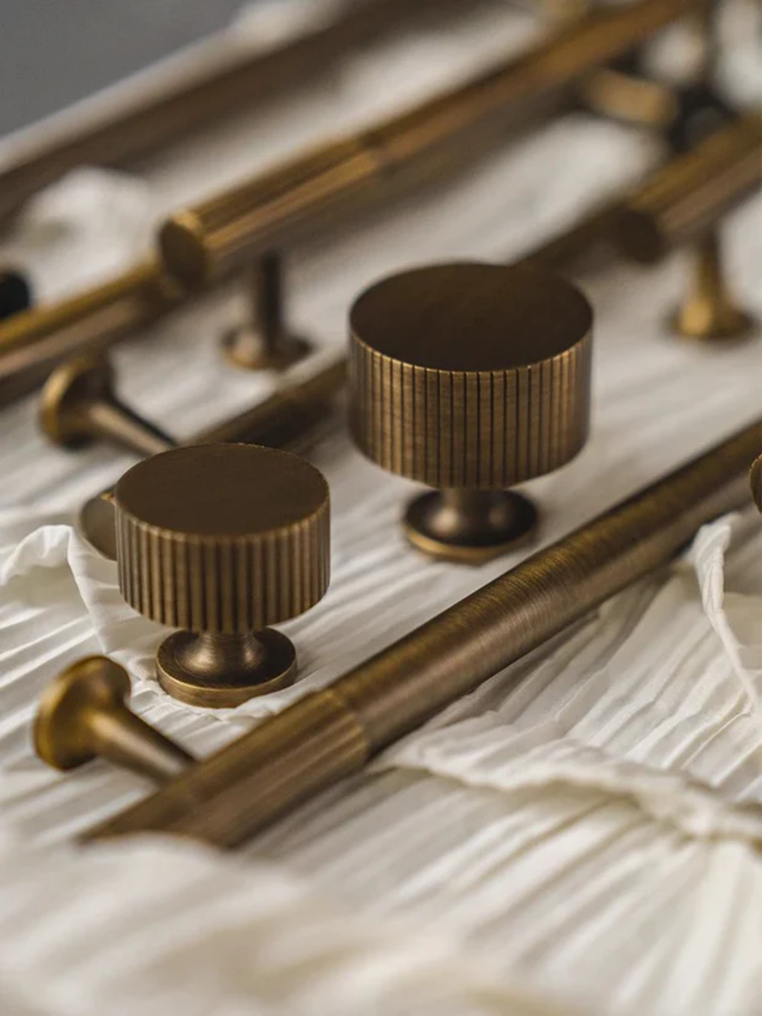 Bronze knobs and handles on a textured surface