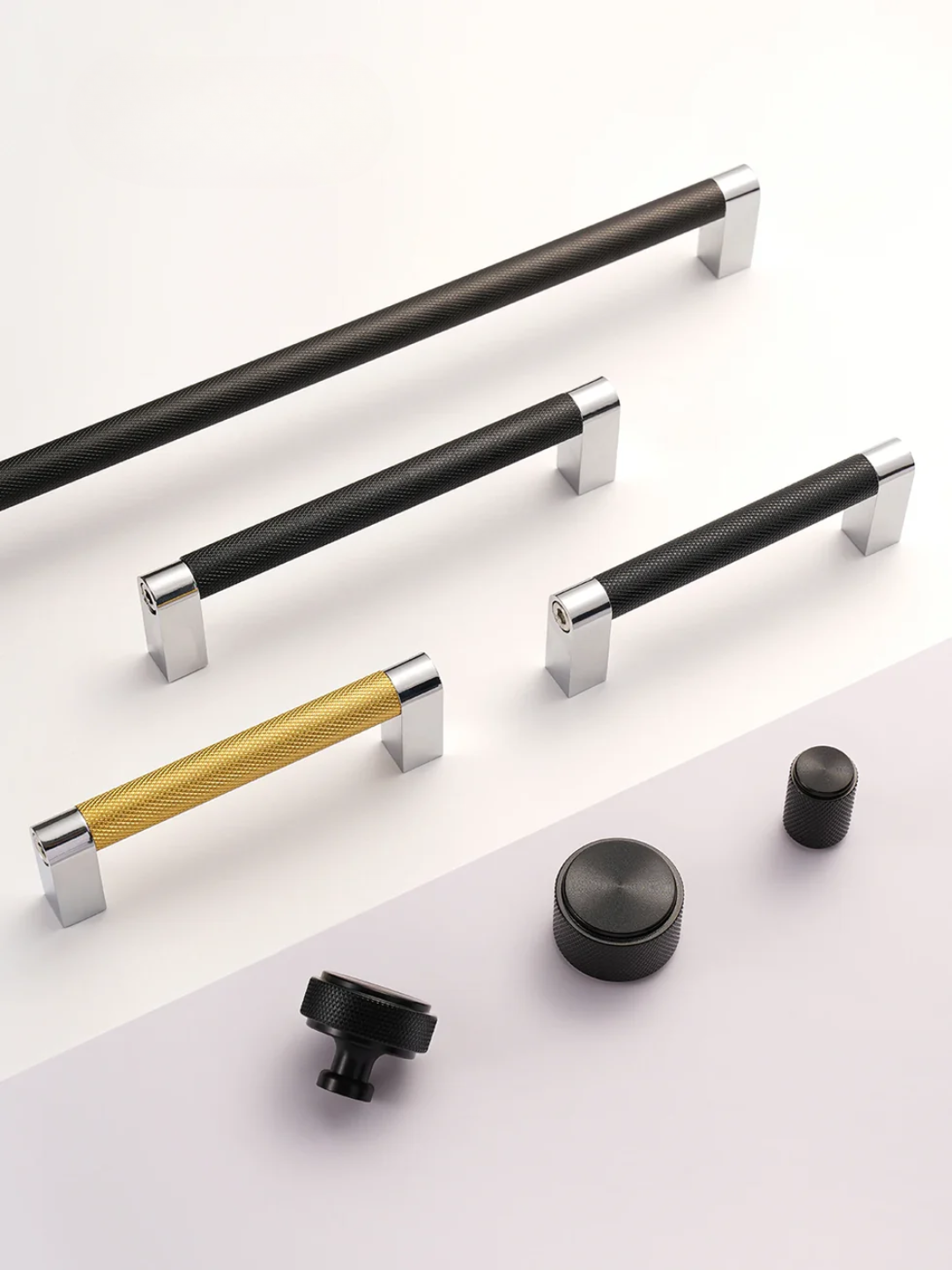 Set of cabinet handles and knobs on a white background