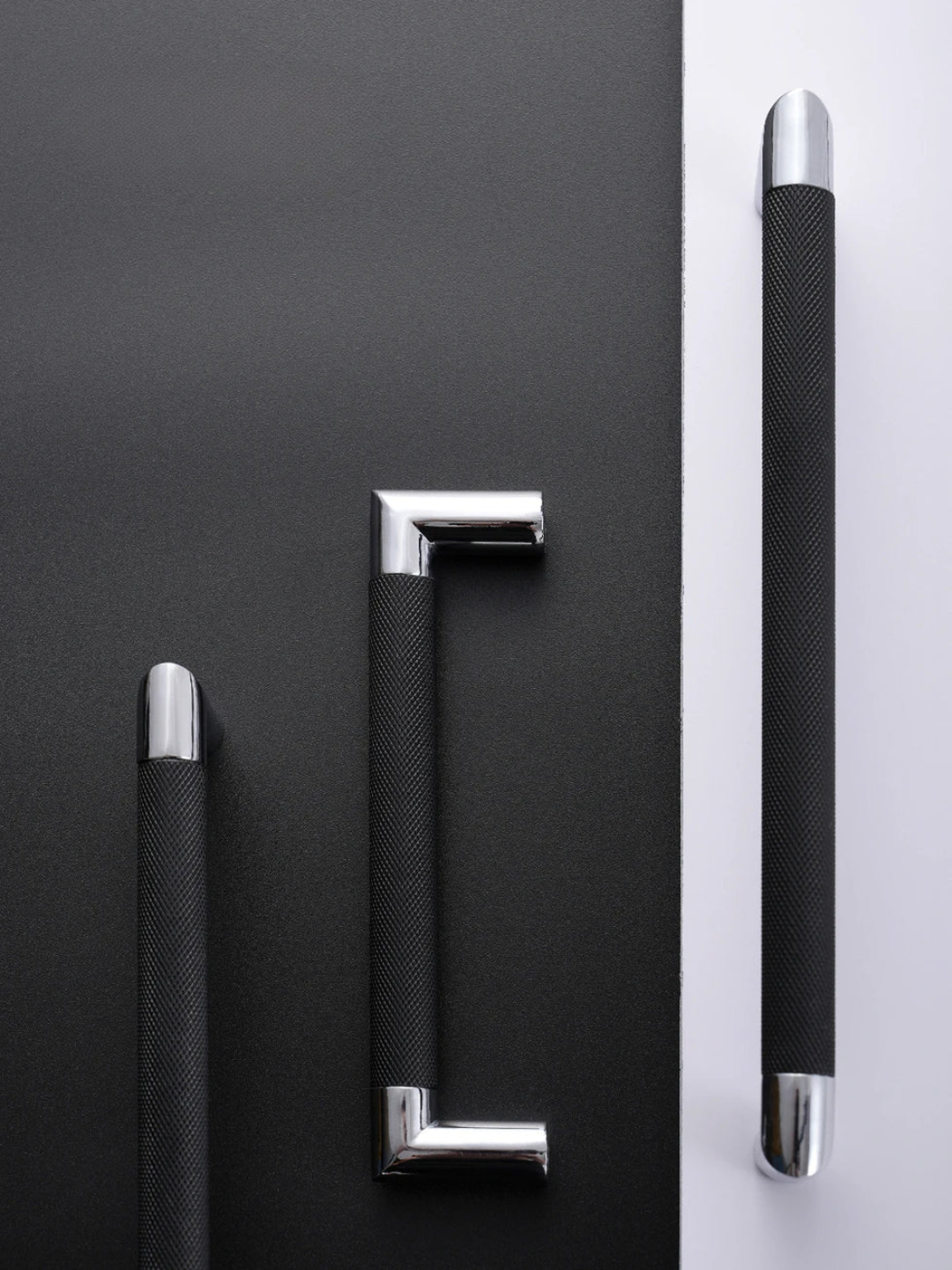 Set of black handles with metallic accents on a black and white background