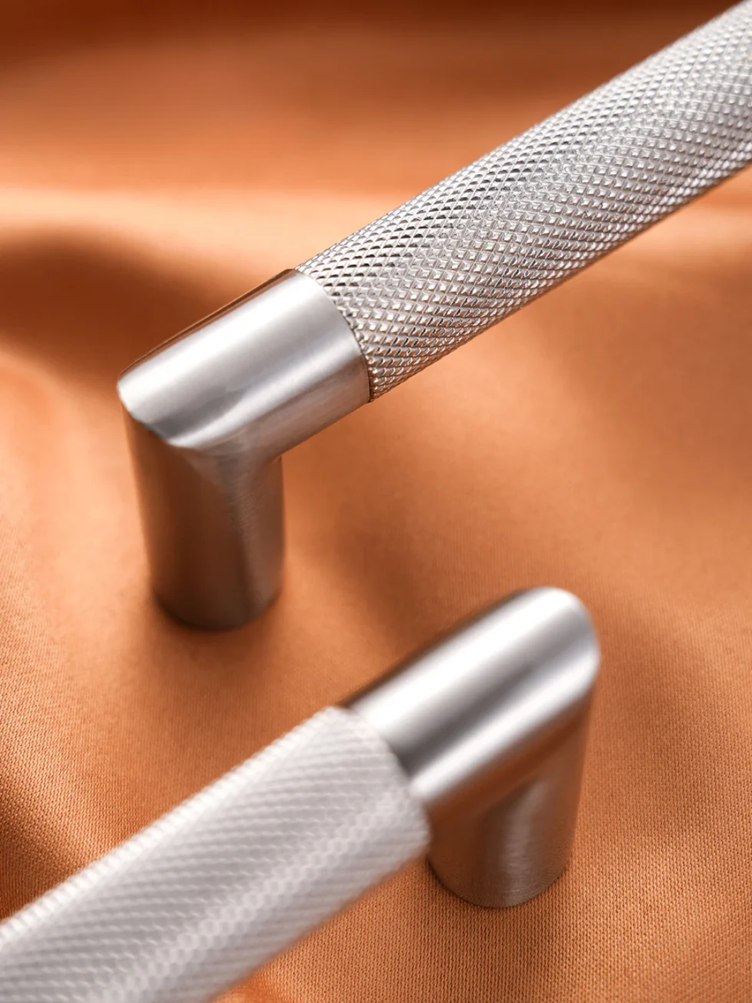 Metallic handles on a brown fabric background with 'SANTAYA' branding.