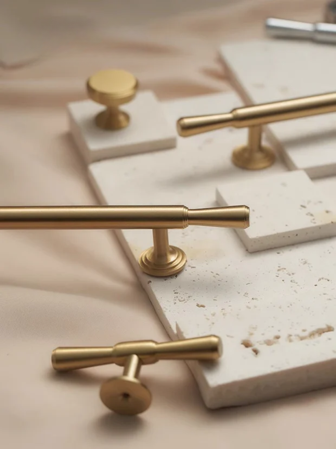 Gold cabinet handles on a marble surface