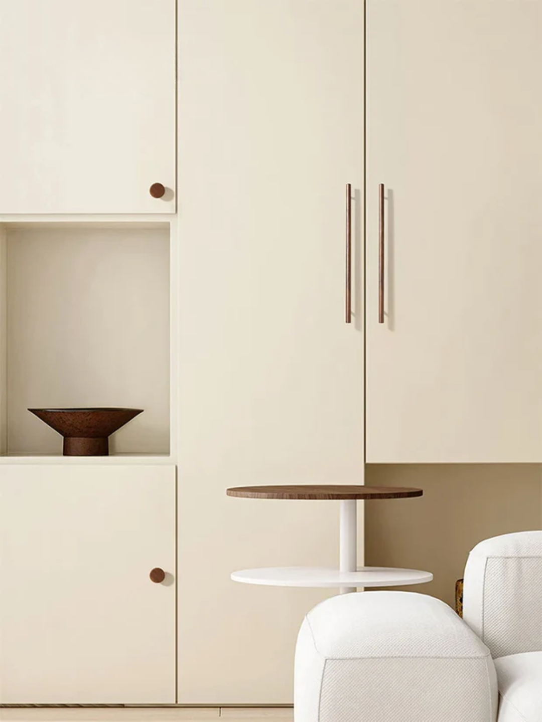 Beige kitchen cabinets with a small round table and white chair.