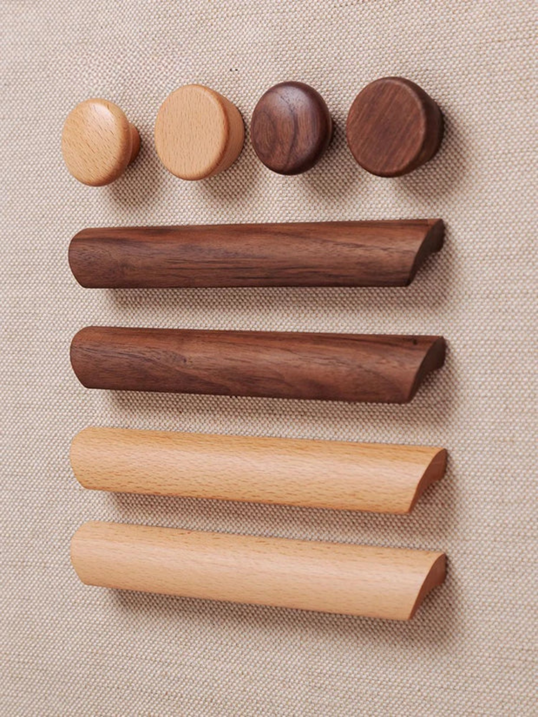 Set of wooden cylindrical objects on a beige fabric background