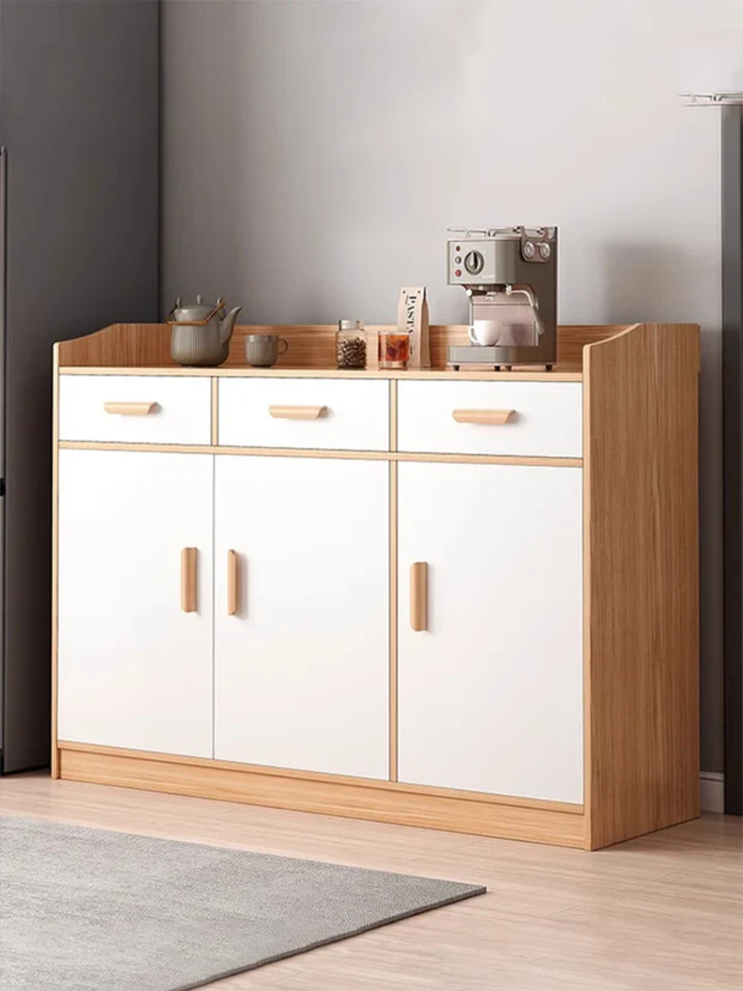 Wooden kitchen cabinet with white doors and wooden top in a modern kitchen setting.