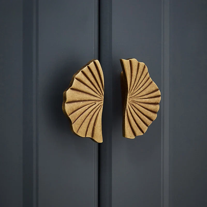 Decorative gold door handles on a dark gray door