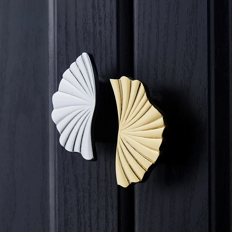 Decorative metal knobs in gold and silver on a textured surface