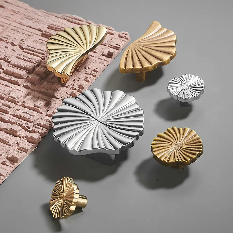 Decorative metal knobs in gold and silver on a textured surface
