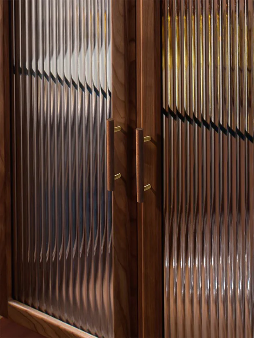 Wooden cabinet with ribbed design and brass handles