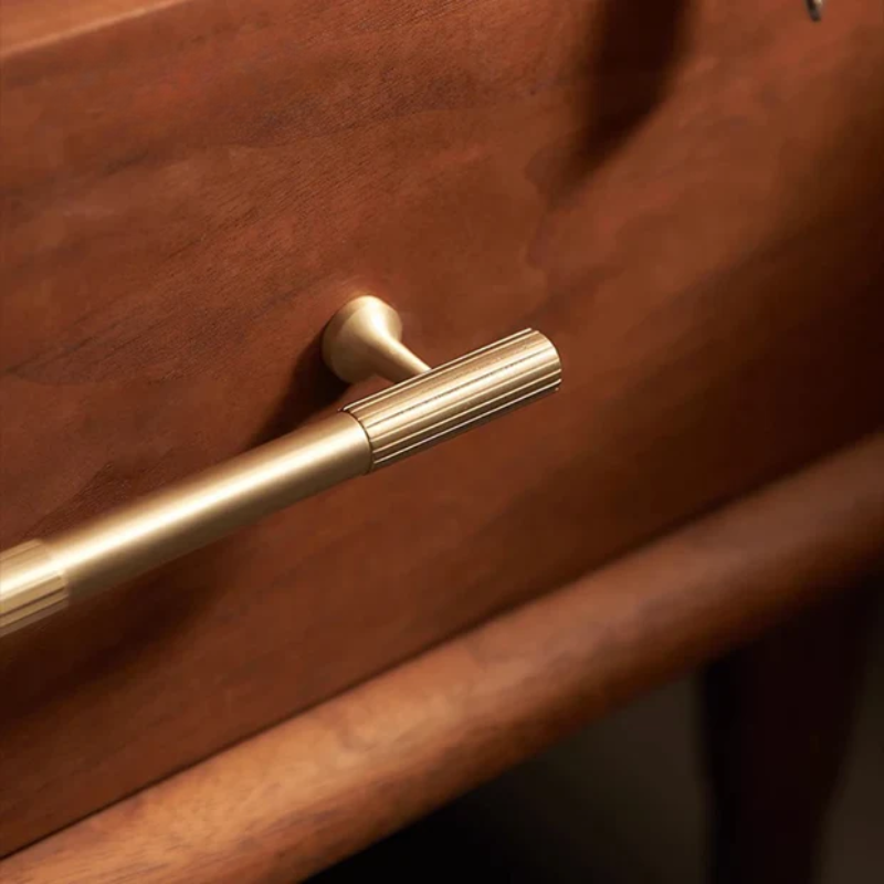 Gold handle on a wooden door