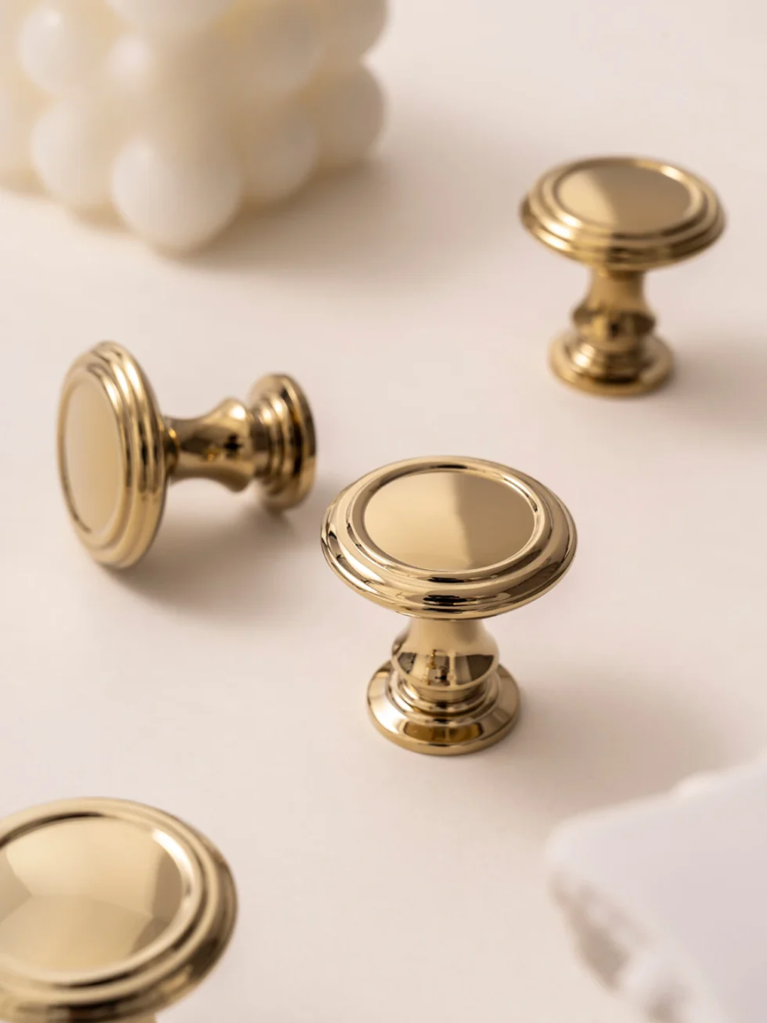 Gold cabinet knobs on a light background