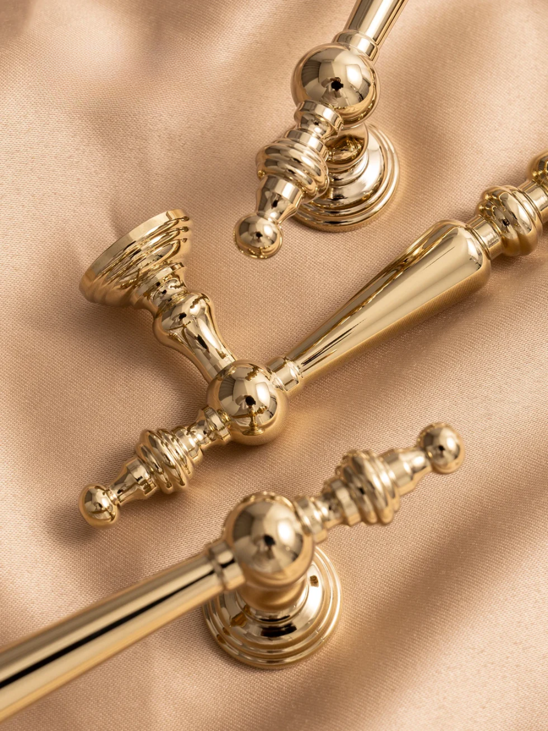 Close-up of gold decorative elements on a beige fabric background