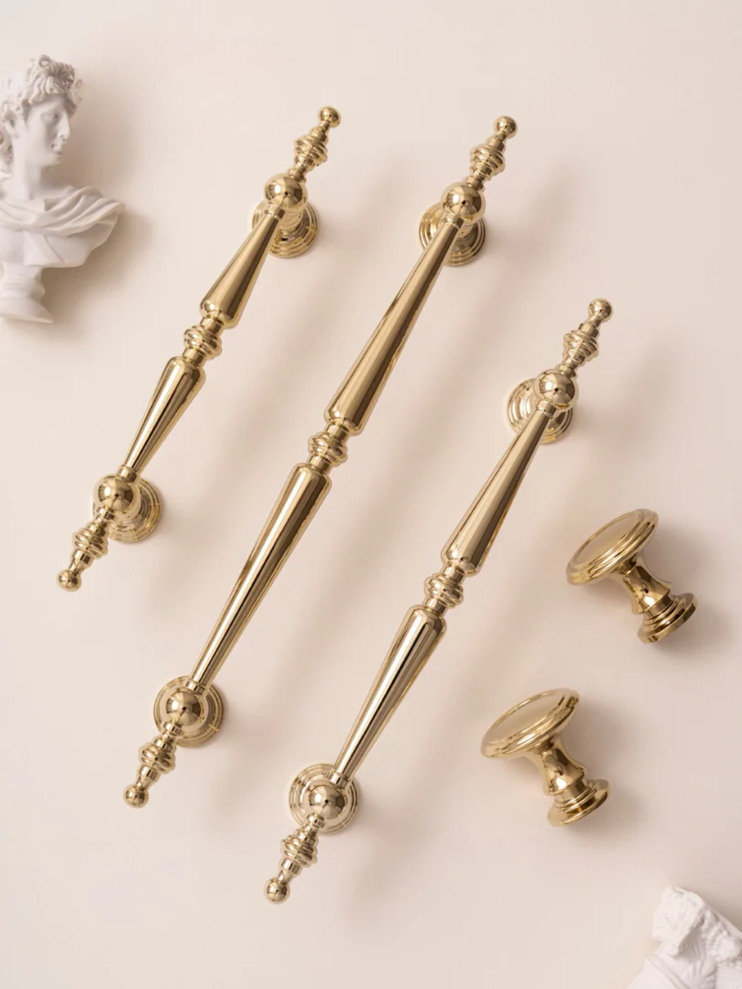 Set of gold decorative handles on a light background