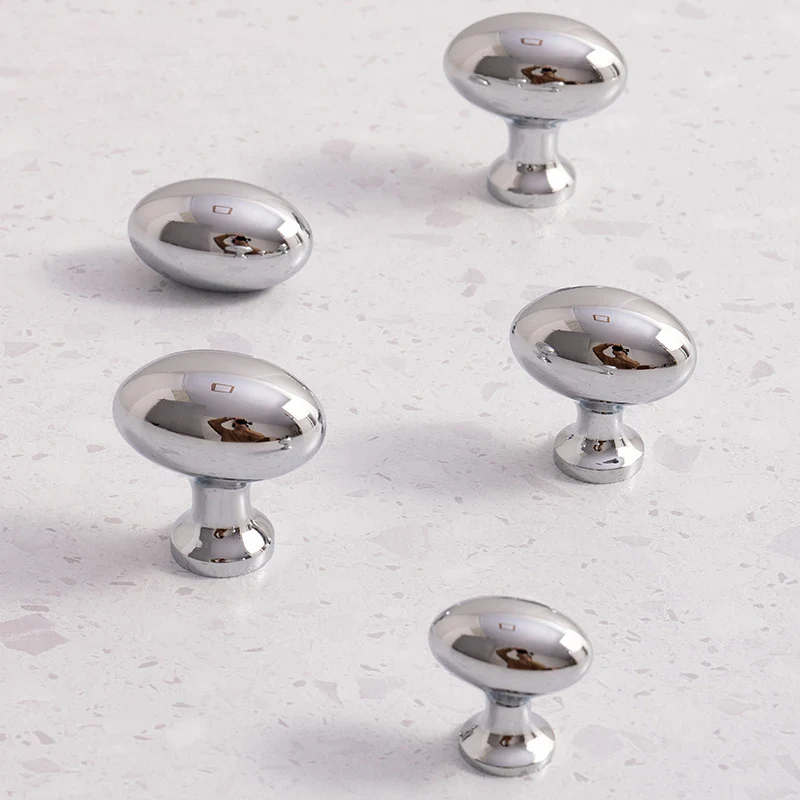 Set of silver cabinet knobs on a light gray surface with 'Santaya' branding.
