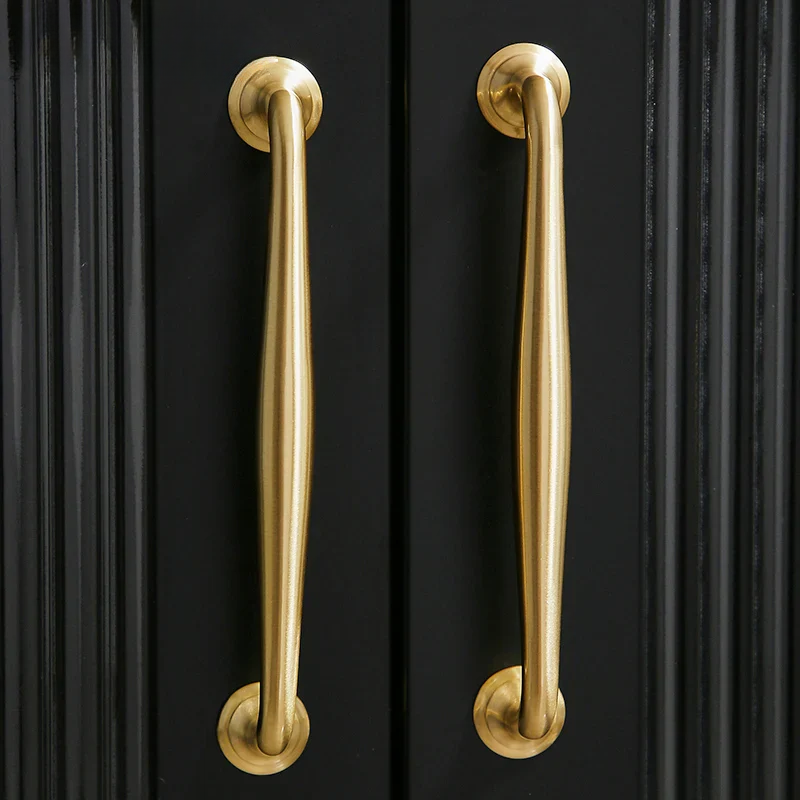 Gold handles on a black cabinet door