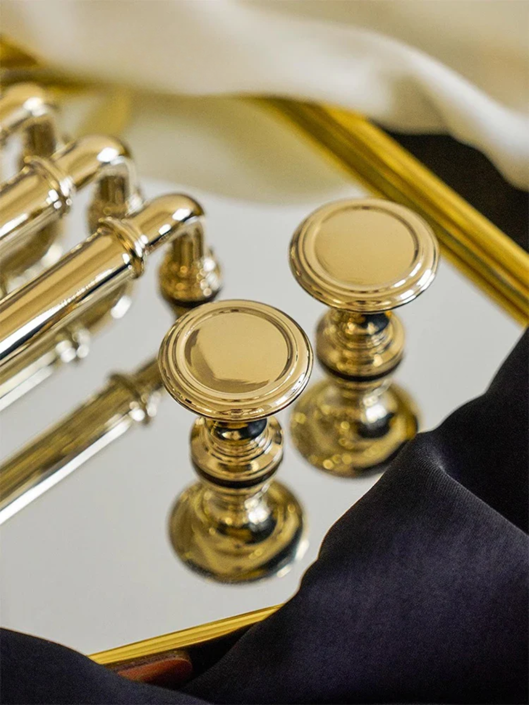 Close-up of a gold musical instrument, likely a French horn, with a reflective surface.