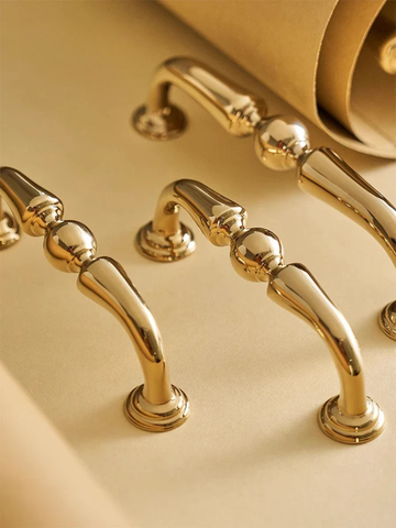 Gold faucet and handles on a beige background