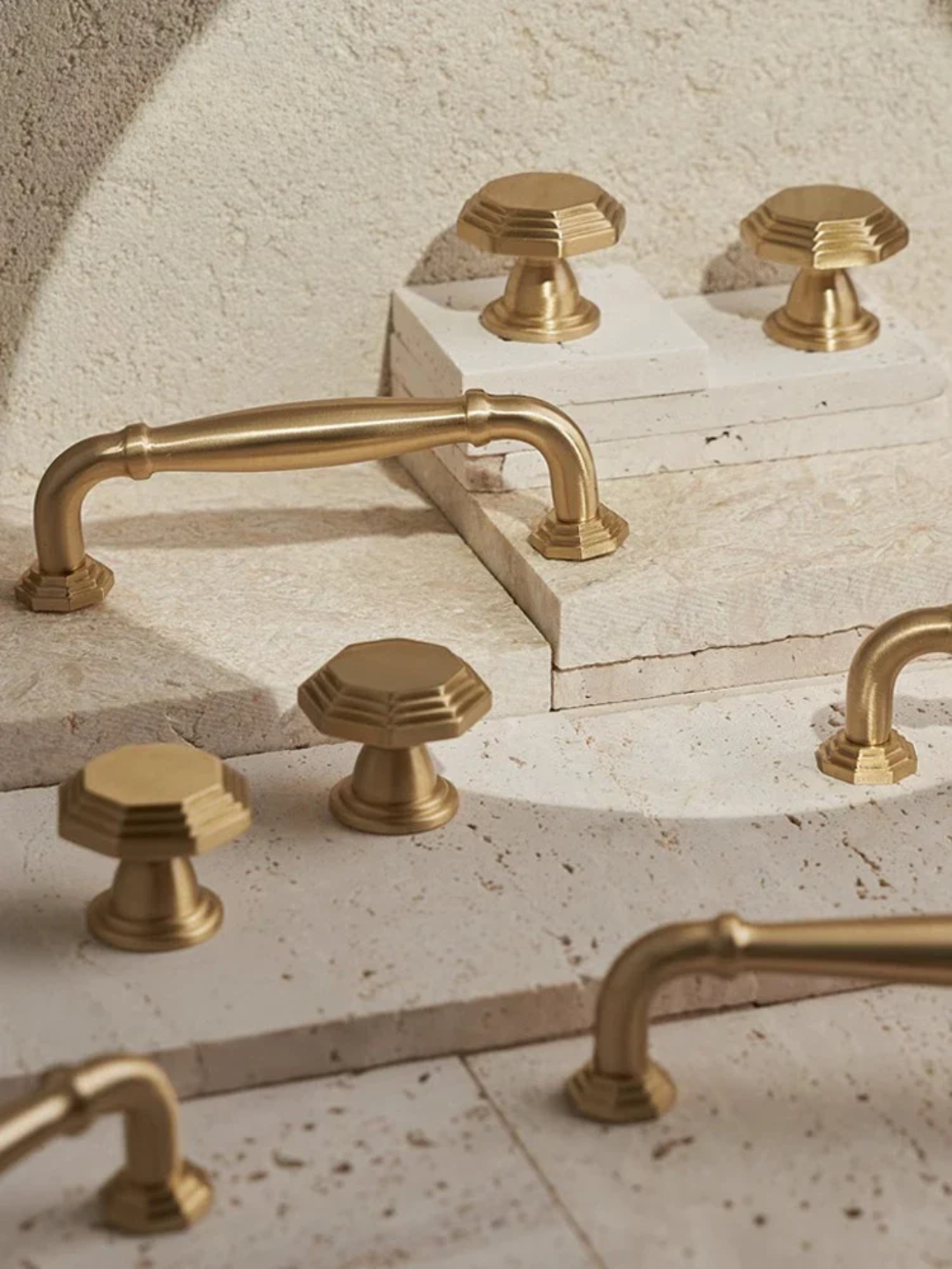Gold bathroom fixtures on a stone surface