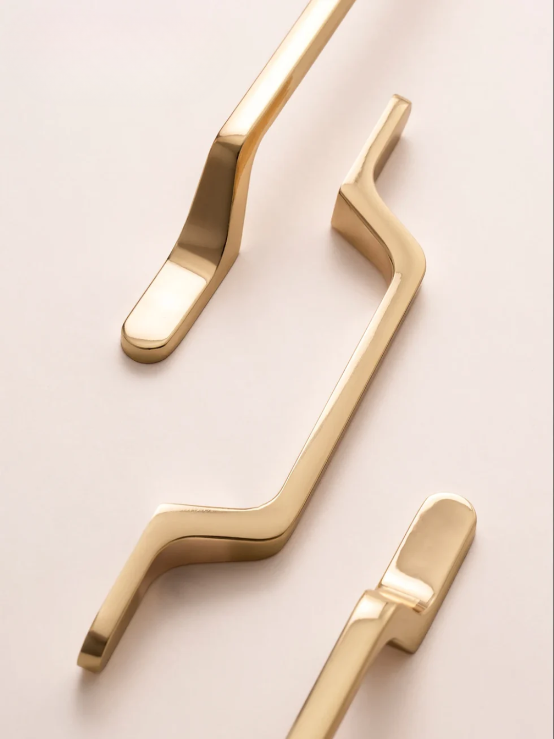 Gold metallic handles on a light background