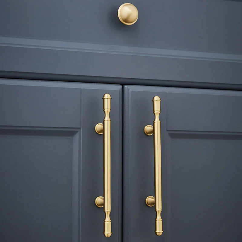 Dark blue cabinet with gold handles and knob