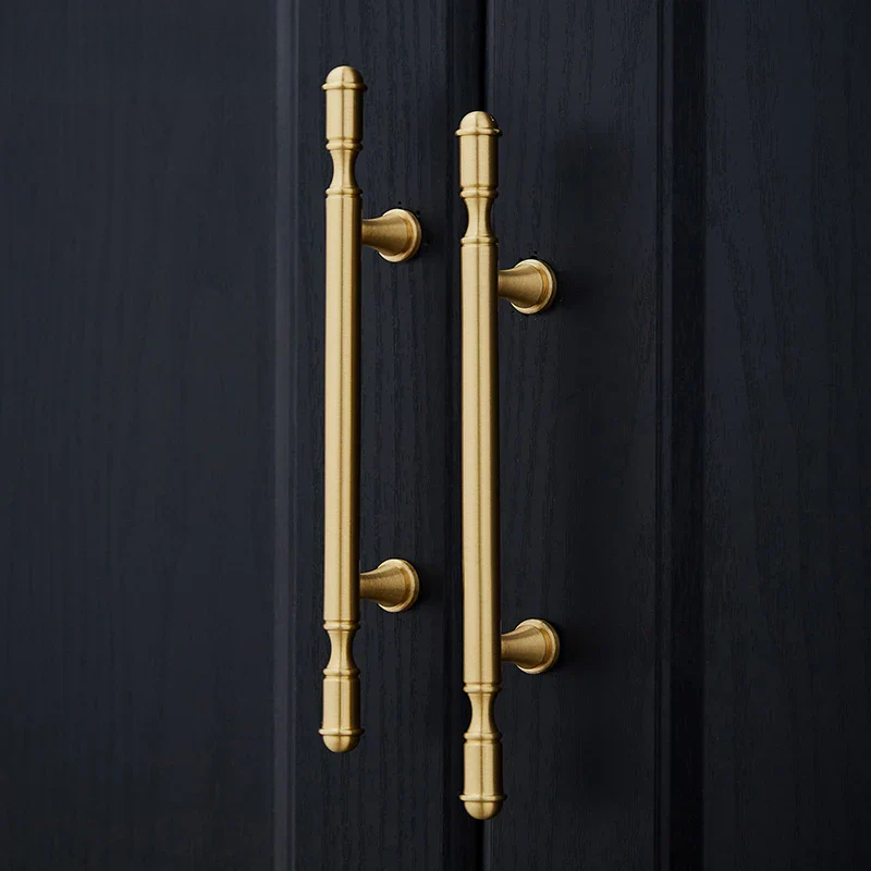 Gold door handles on a black door