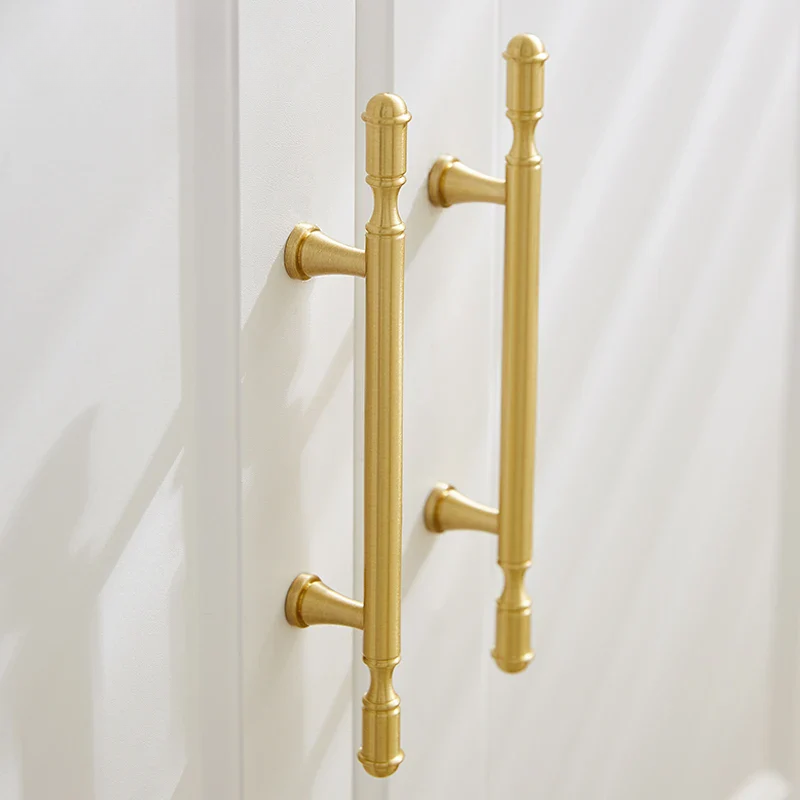 Gold door handles on a white door