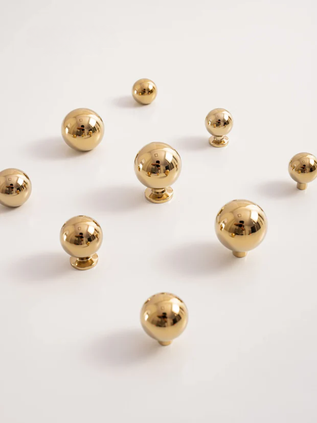 Gold spherical objects on a white background