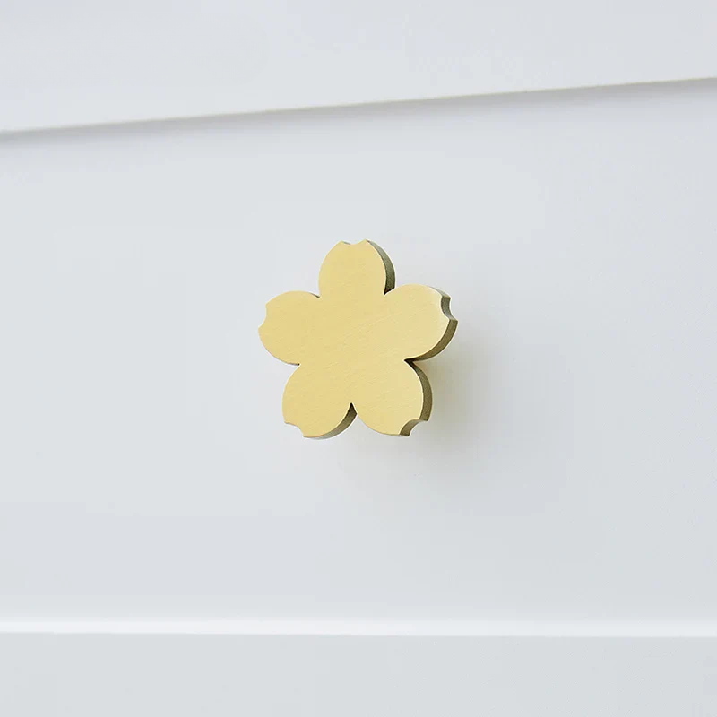 Gold four-leaf clover charm on a white background
