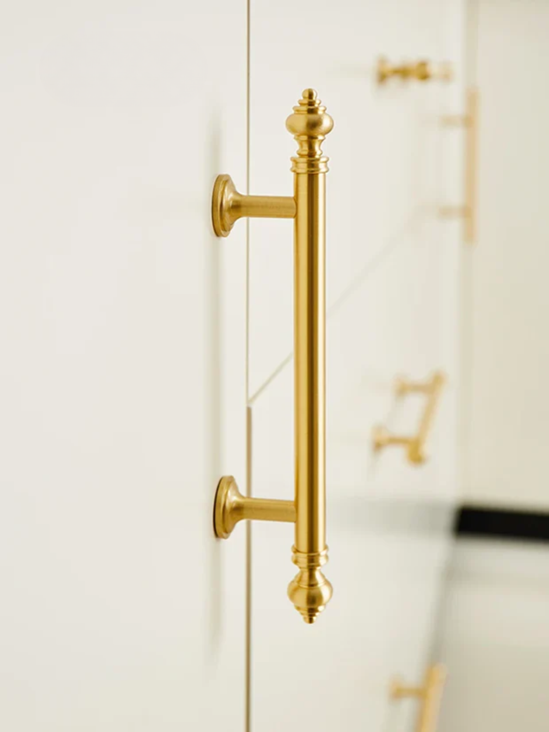Gold door handle on a white door