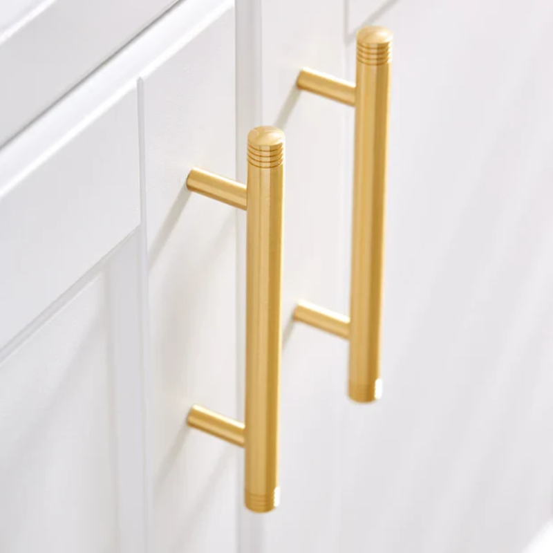Gold cabinet handles on a white cabinet