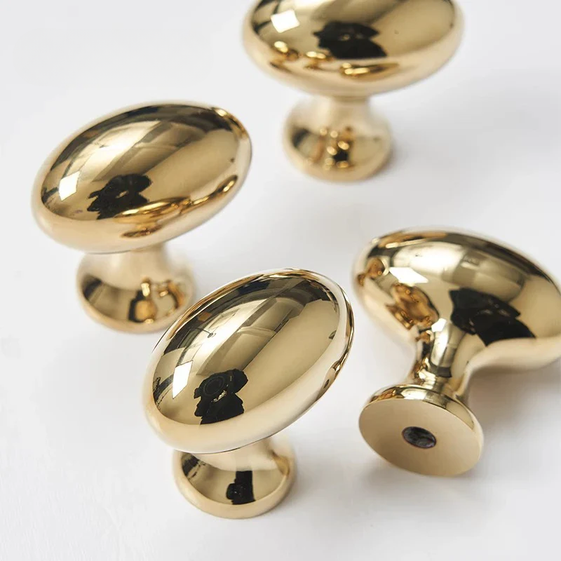 Gold cabinet knobs on a white background